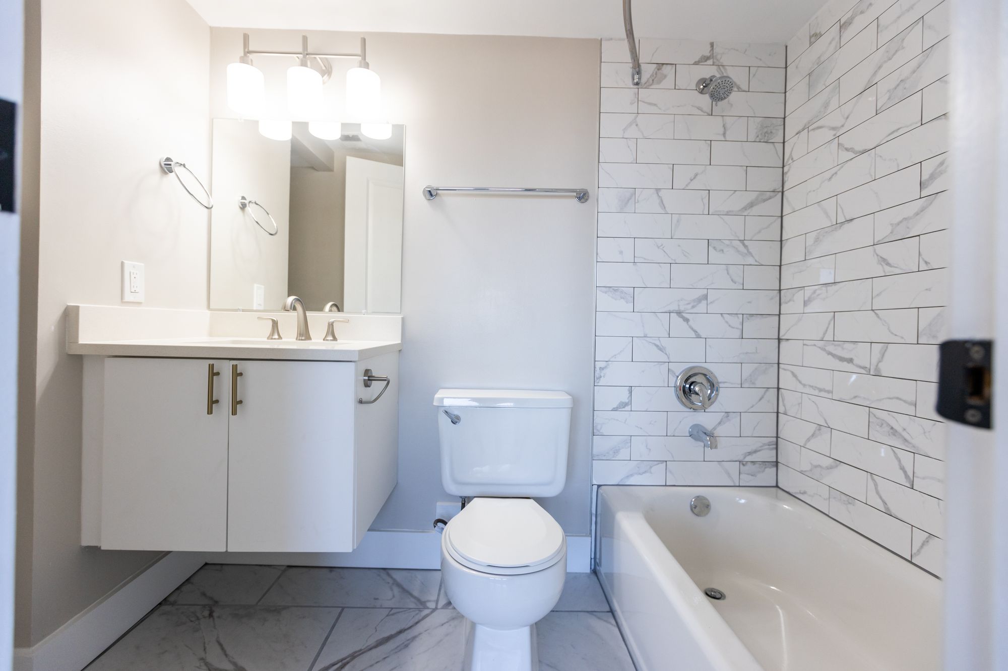 Georgetown Suites renovated bathroom with tiled tub surround